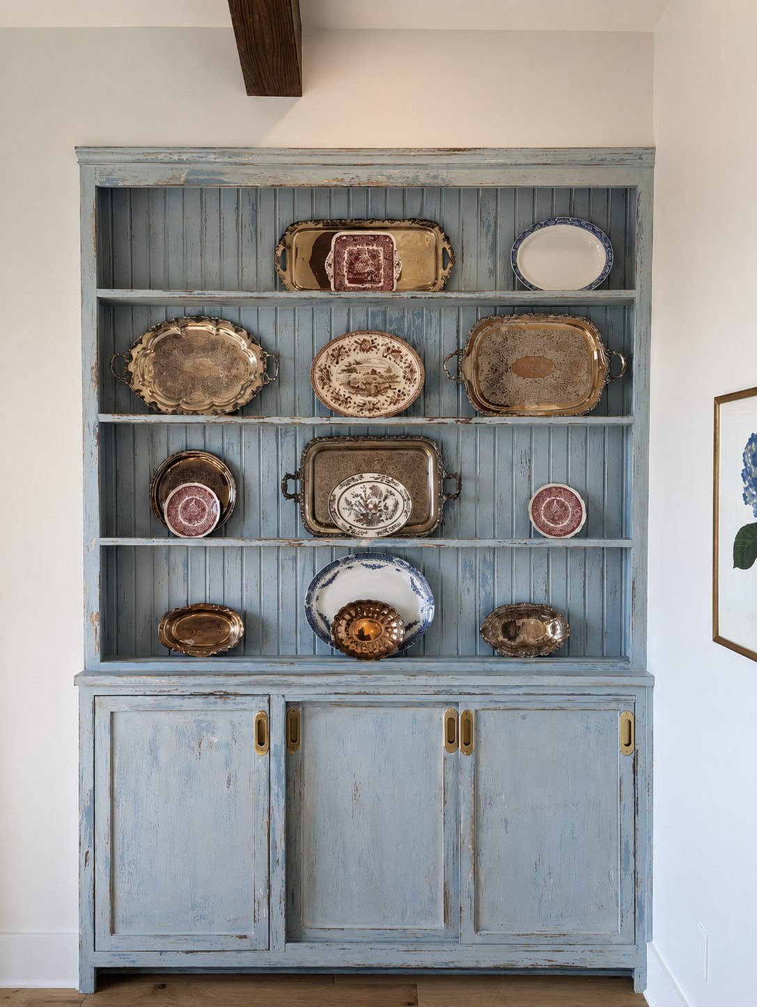 Blue painted hutch cabinet displaying plates