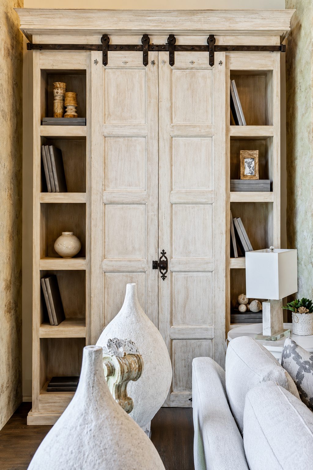 Painted barn door beside custom shelving