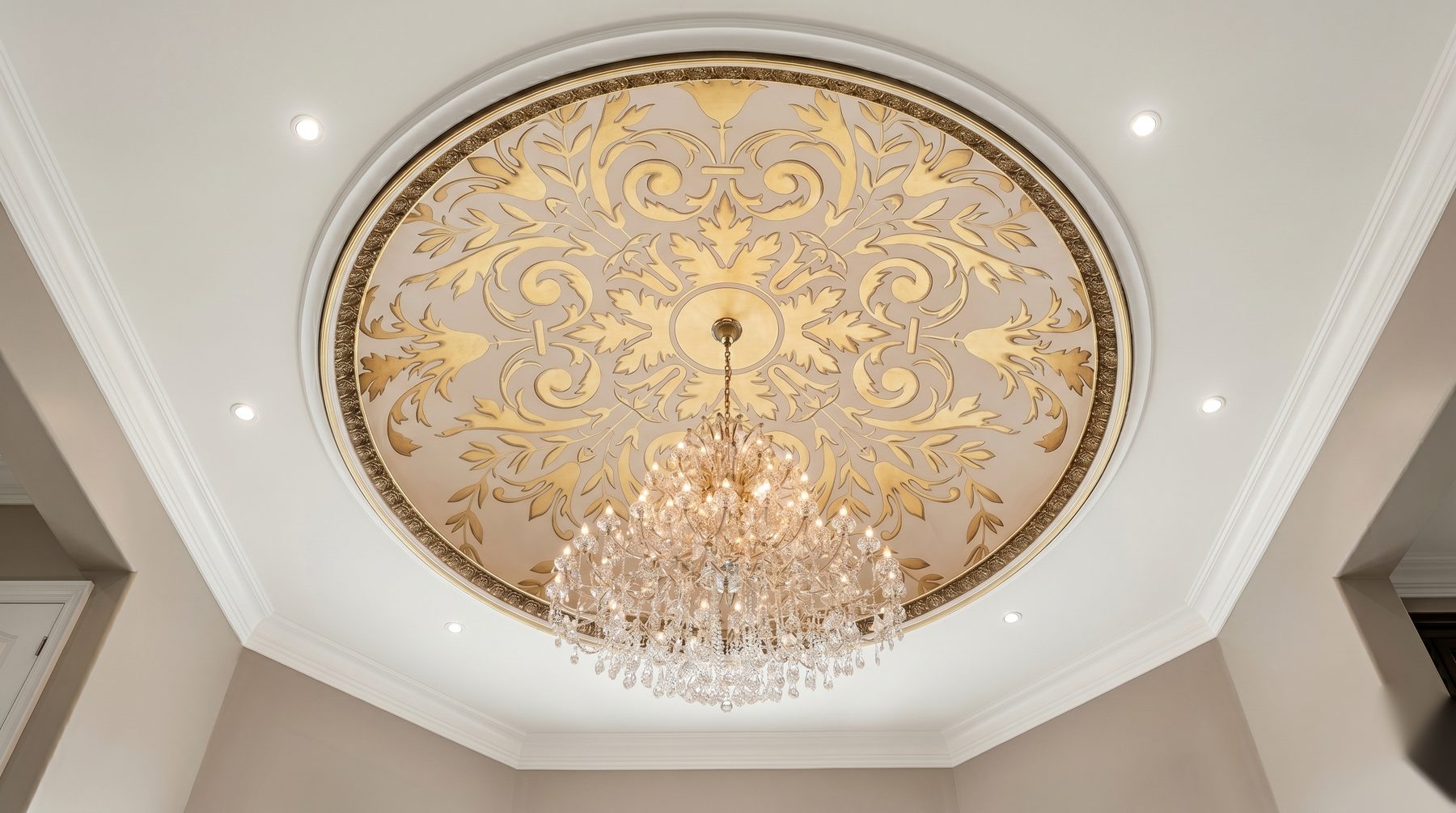 Ornate gold painted ceiling with a crystal chandelier