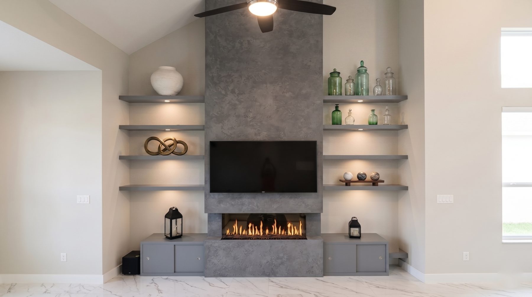 Gray plaster fireplace wall with a mounted television