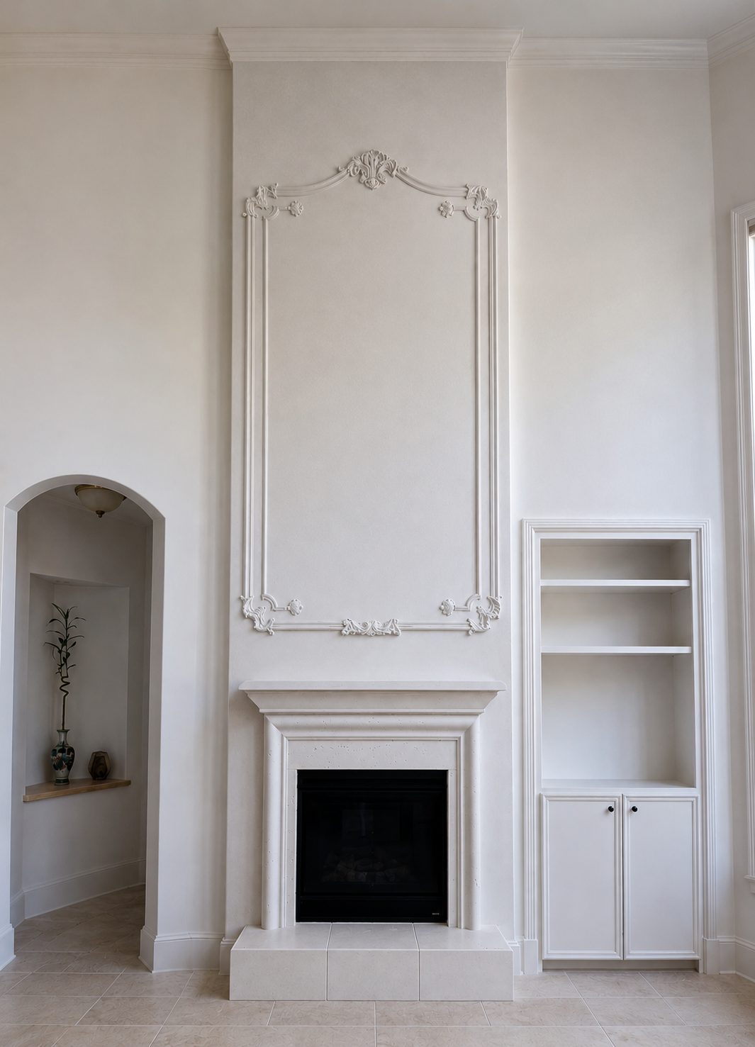 White living room with a niche fireplace in decorative plaster