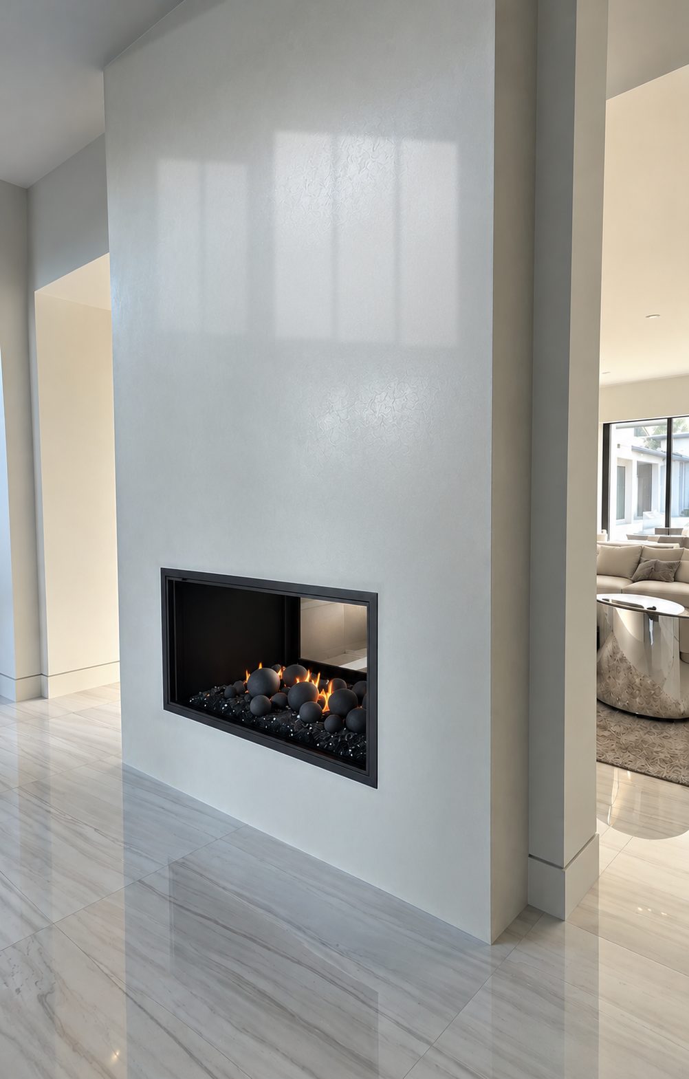 See-through fireplace set in a seamless wall of polished, light-catching plaster