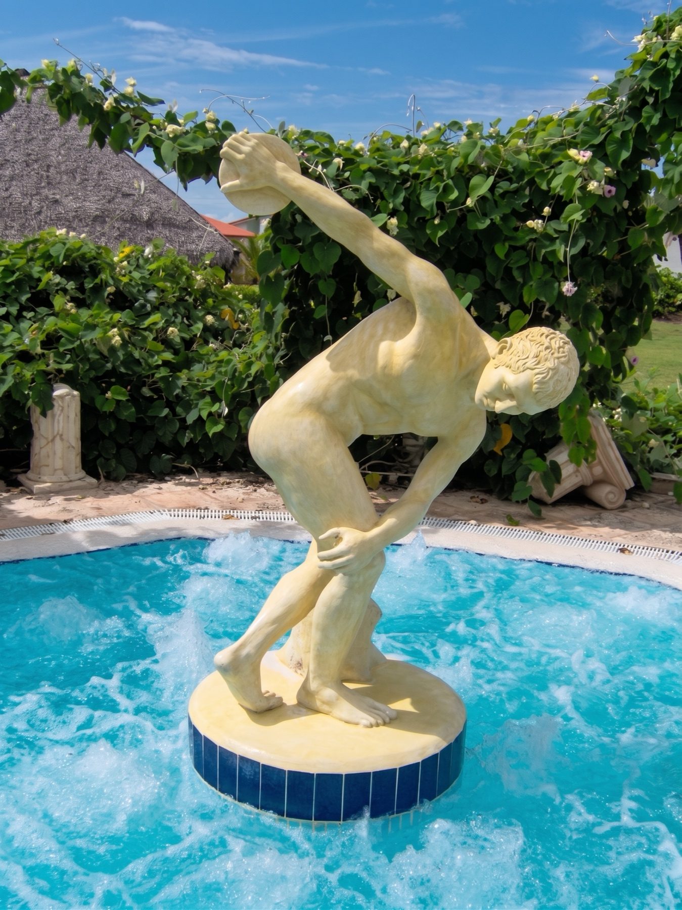 Hand-sculpted figure on a pedestal above a swimming pool, an original specialty art piece